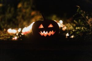 A glowing jack-o'-lantern with carved face surrounded by candlelight, perfect for Halloween ambience.